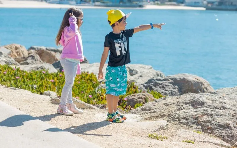 Child wearing the best kids GPS watch outdoors during holiday shopping season